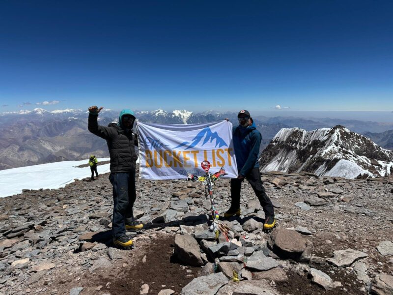 Bucket List Company flag displayed on the summit of Mount Aconcagua in Argentina