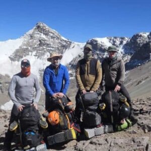 Aconcagua expedition team standing with backpacks at high altitude in the Andes Mountains