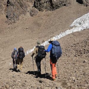 Climbers ascending rocky slopes on Mount Aconcagua during summit push
