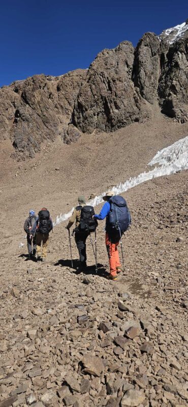 Climbers ascending rocky slopes on Mount Aconcagua during summit push