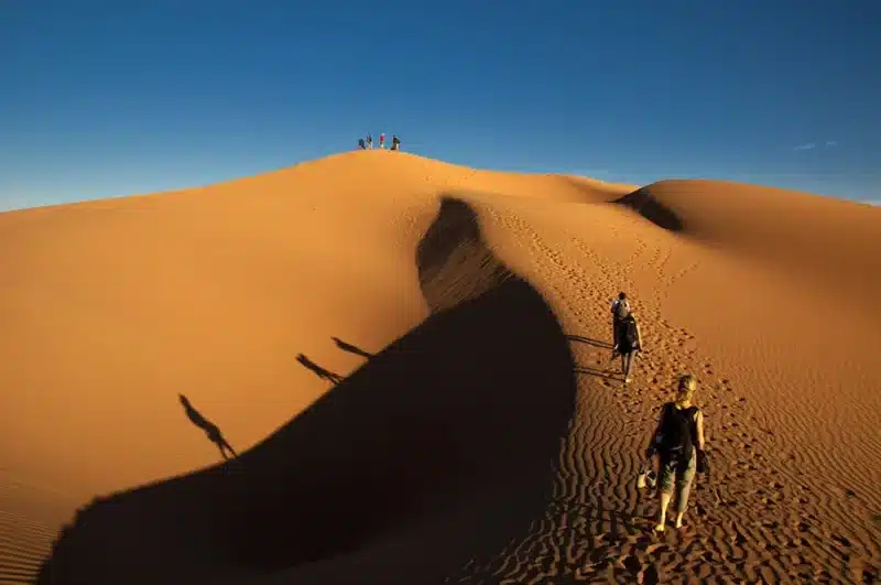 Climbing up sand hill Sahara Desert, TBLC