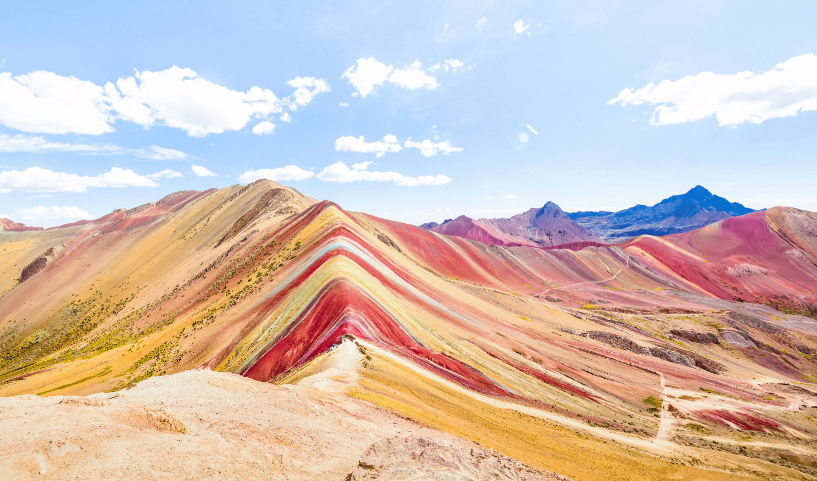 Hiking trail across Rainbow Mountain with vibrant mineral colours in Peru