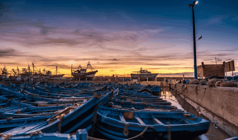 Sunset over Essaouira harbour with traditional fishing boats, Morocco