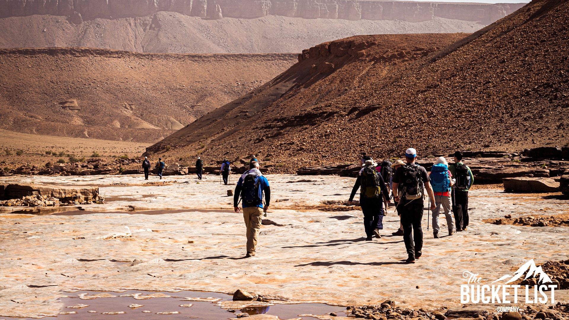 a Group of trekkers walking through the sahara desert