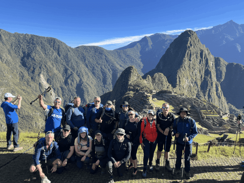 Bucket List Company trekkers at Machu Picchu with mountain backdrop