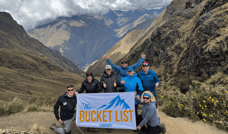 Group of Bucket List Company trekkers celebrating in the Andes mountains