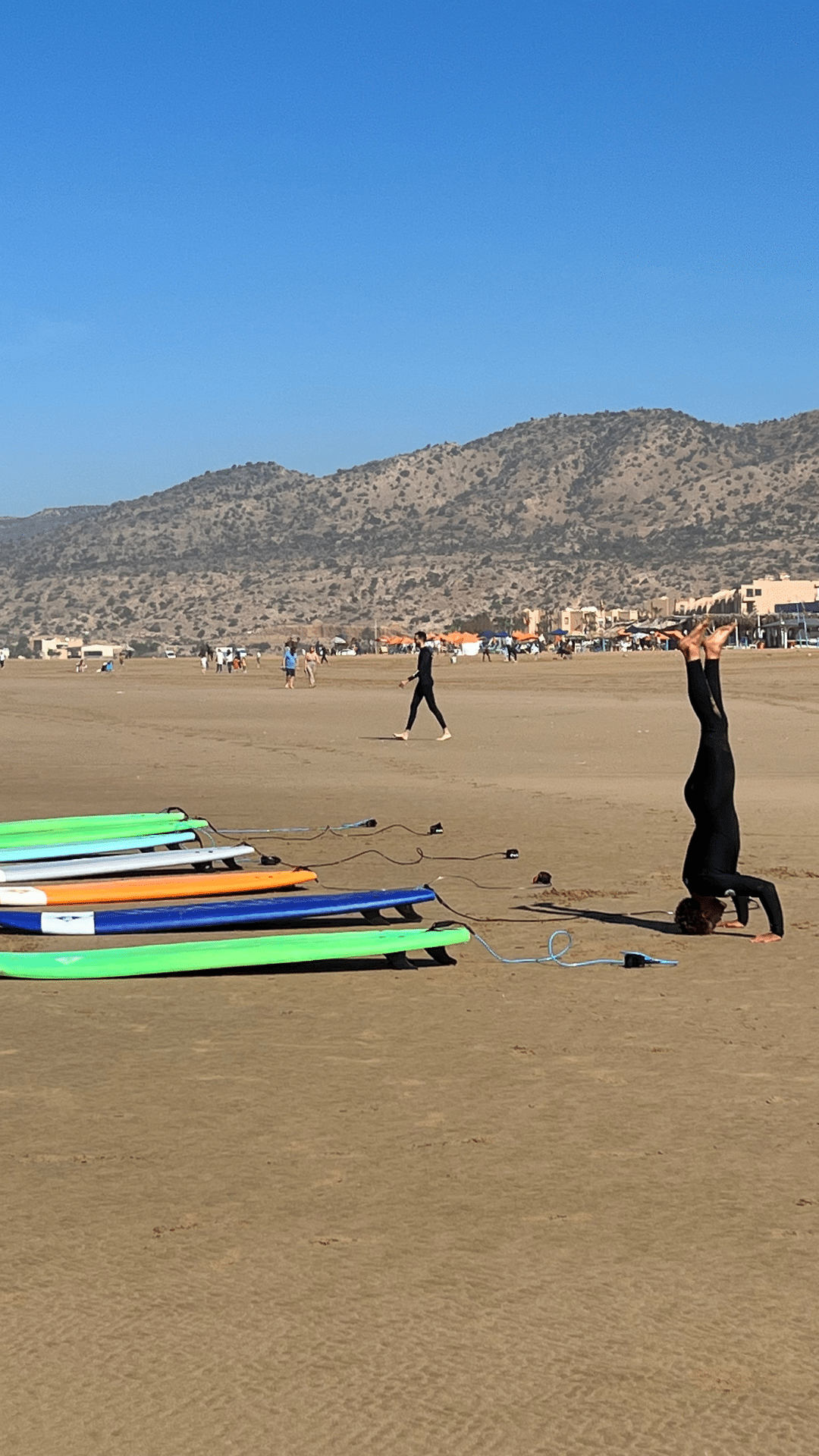 Experience the Ultimate Surf and Yoga Retreat in Morocco - women doing headstand at beach