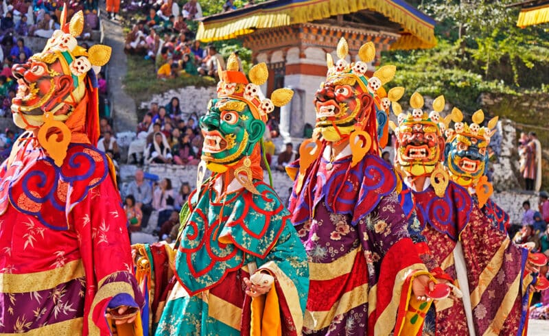 Performers dancers wearing masks in festival in Mongar Bhutan