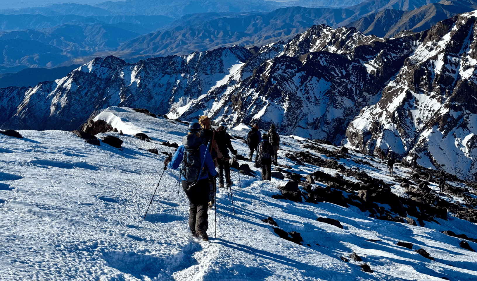 Trekkers ascending snowy slopes on the Mount Toubkal winter trek