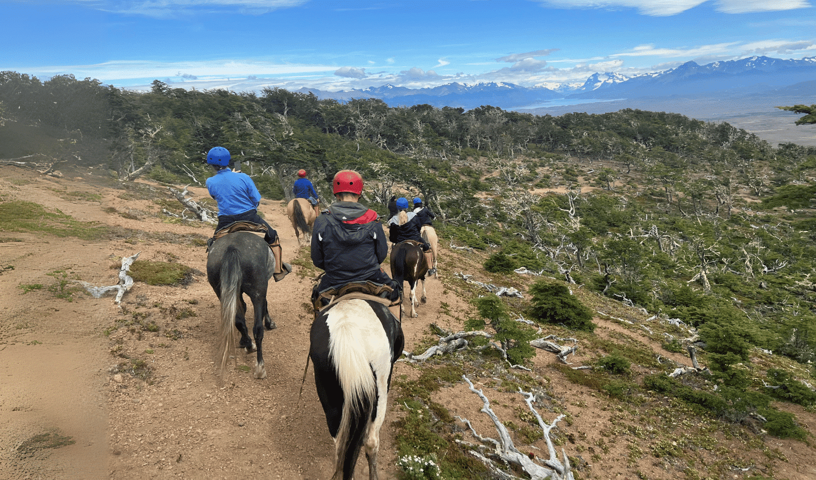 Horseback riding through Patagonian wilderness with mountain views on a Patagonia adventure