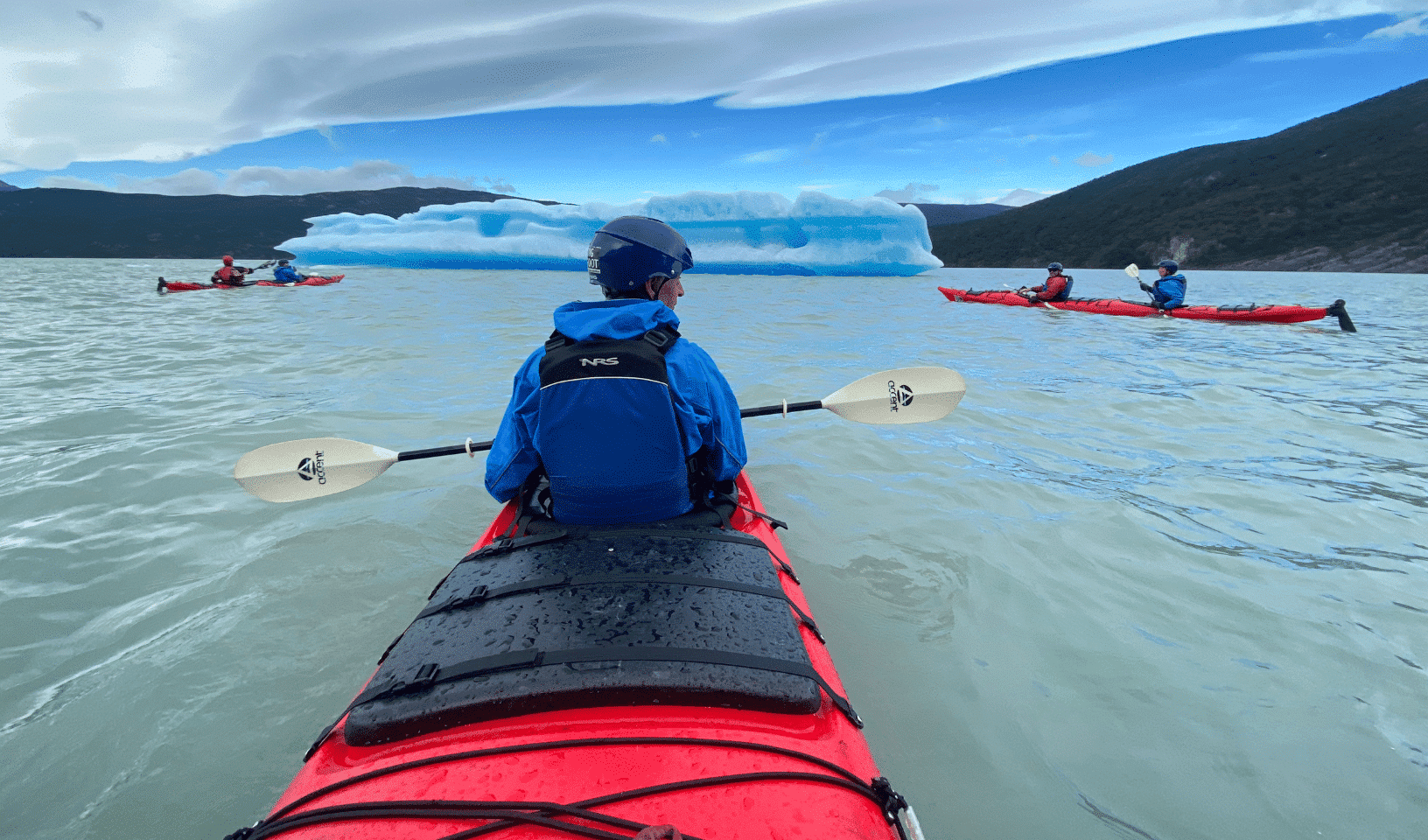Kayaking on a glacial lake in Patagonia with icebergs and snow-capped mountains
